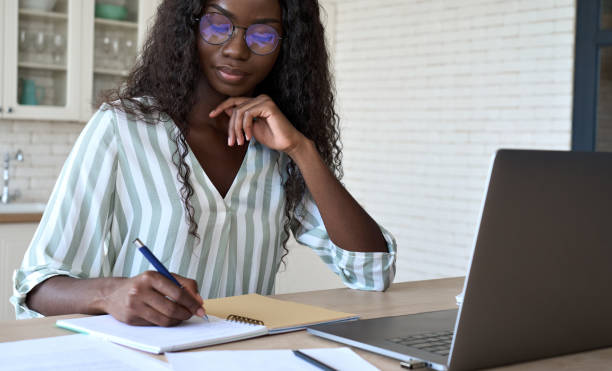istock Young black African woman student learning online using laptop at home. 1347465679