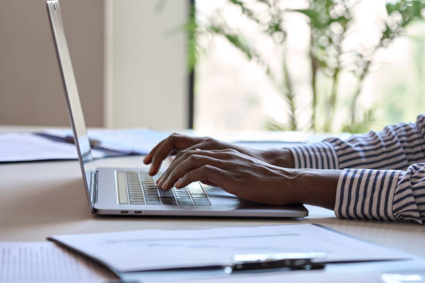 istock Young African black female hands typing on laptop computer keyboard. 1347465795