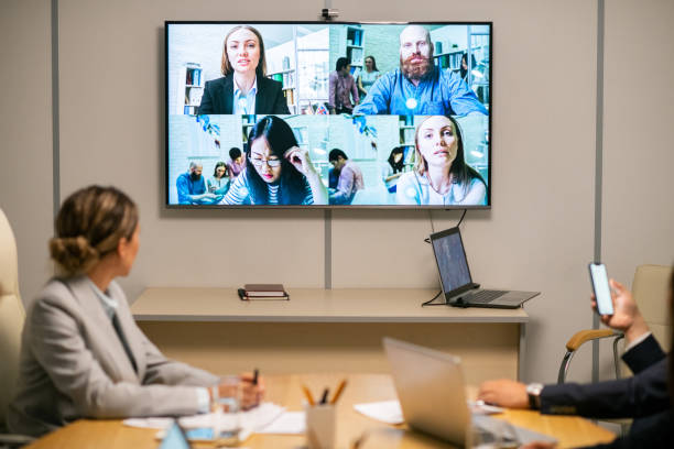 istock Several business people on large display hanging on wall of boardroom 1347466072