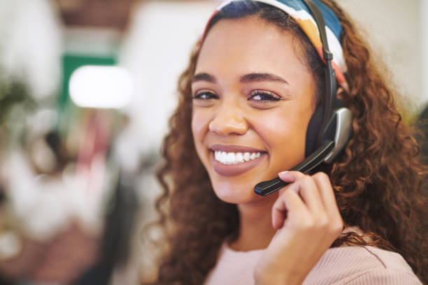 Shot of an attractive young businesswoman wearing a headset in the office during the day stock photo