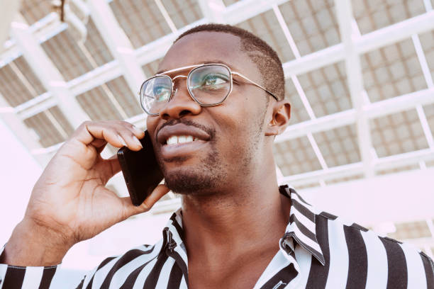 istock Black man talking by mobile phone outdoors 1347467784
