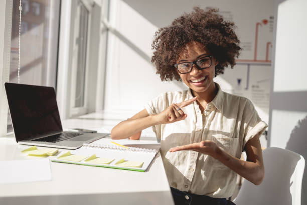 istock Afro American woman at the table and gesturing with her hands 1347470147