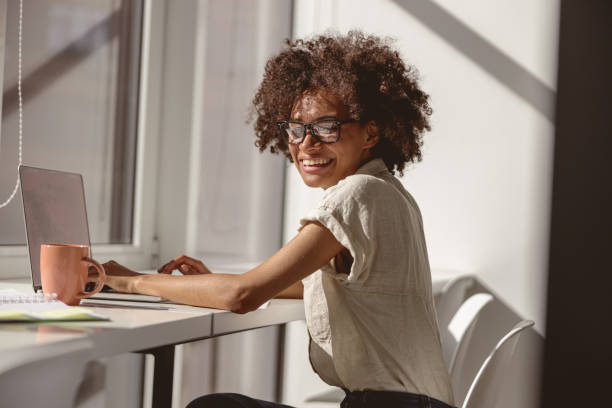 istock Pretty multiethnic woman sitting at her workplace 1347470161