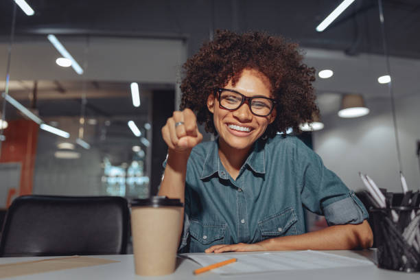 istock Friendly pretty woman using sign language in the office 1347470346
