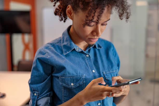 istock Afro American female employer chatting while texting on phone 1347470368