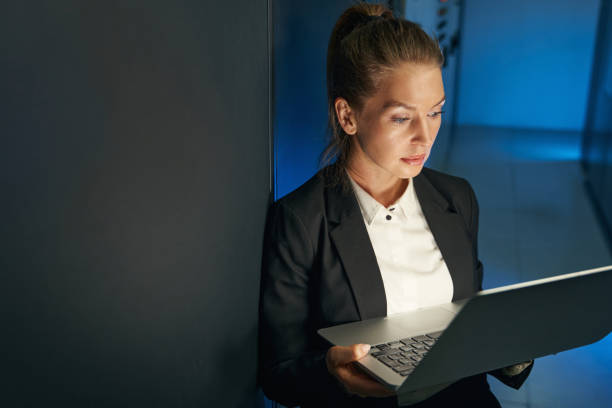istock Engineer businesswoman works in network server room 1347472395