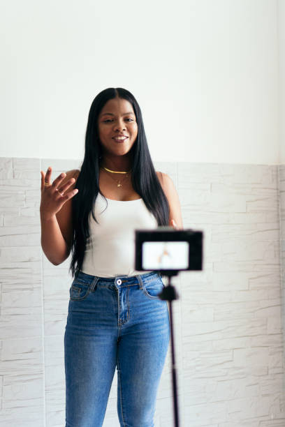 istock Woman records herself with her camera at home 1347473824
