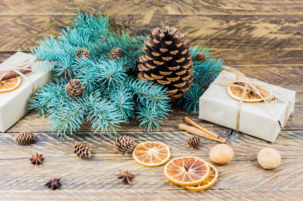 istock Christmas festive background with natural ingredients - branches of blue spruce, cedar cone, walnuts, orange slices, cinnamon and anise. 1347473957