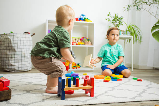 istock Cute Boy Playing With Toy On Floor 1347476937