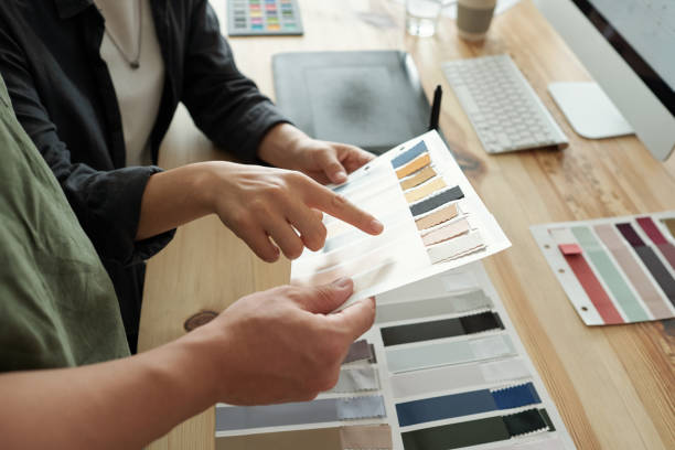 istock One of two designers pointing at textile sample 1347478642