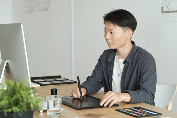 istock Young contemporary graphic designer drawing something 1347478656