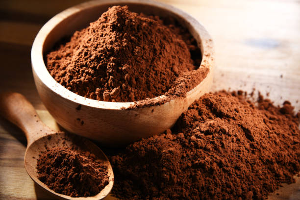 istock Composition with bowl of cocoa powder on wooden table 1347480515
