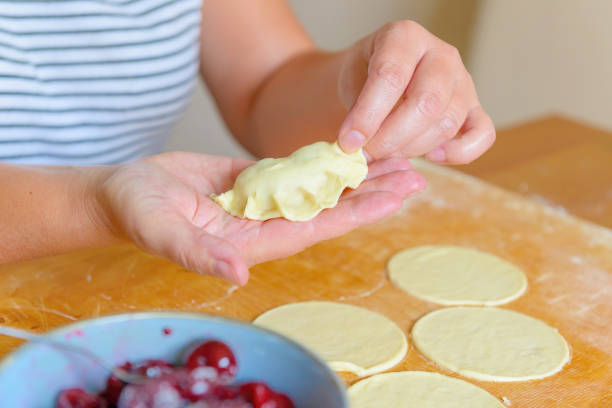 istock Making dumplings filled with sour cherry with sugar 1347482028