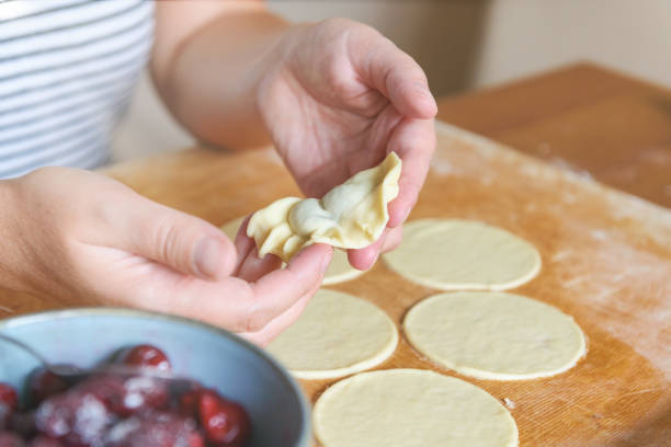 istock Making dumplings filled with sour cherry with sugar 1347482066