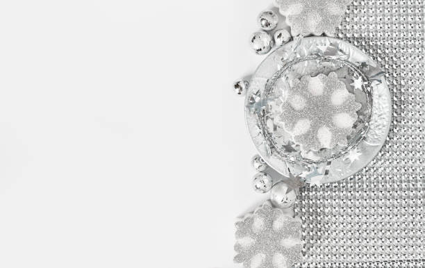 istock silver snowflakes on a white background with copy space 1347483120