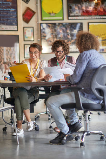 istock group of colleagues reading the files, smiling, working together 1347483397