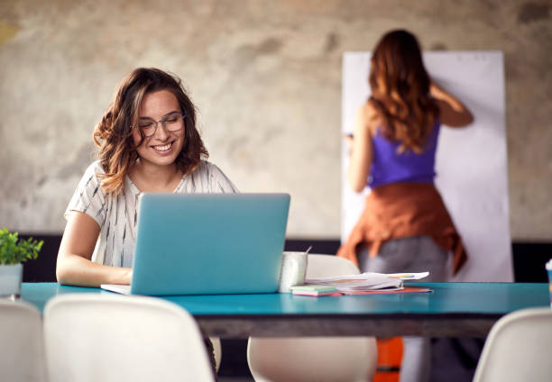 istock Young woman is in a good mood while working in the office 1347486052