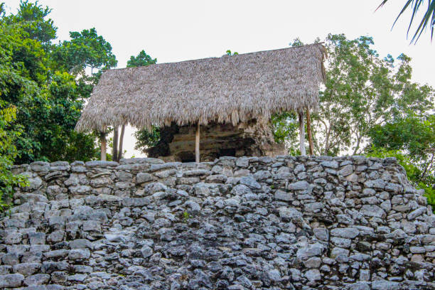 istock THATCHED HUT ATOP ANCIENT MAYAN PYRAMID AND RUINS IN JUNGLE 1347486260