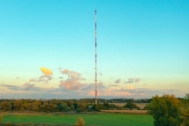 istock Telecommunication tower with antennas on blue sky background 1347487904