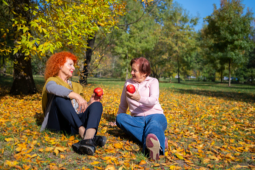 Senoir womans talking at the park in autumn