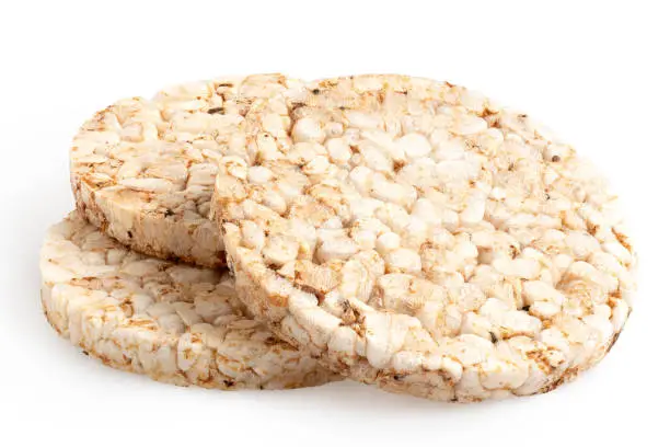 Three plain puffed brown rice cakes isolated on white.