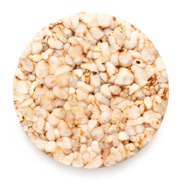 Plain puffed brown rice cake isolated on white. Top view.