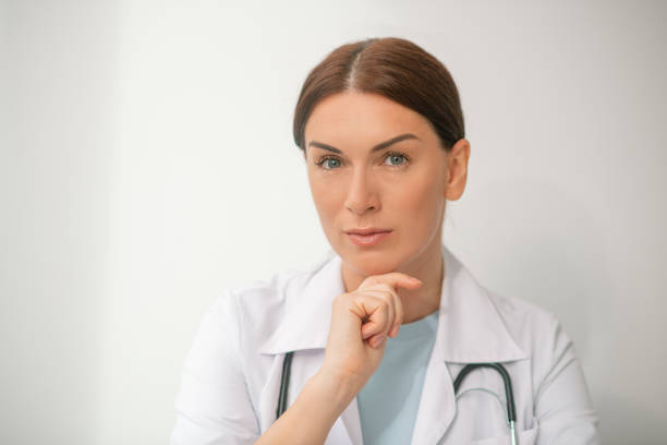 istock Pretty woman in a white robe on a white baxkground 1347491018