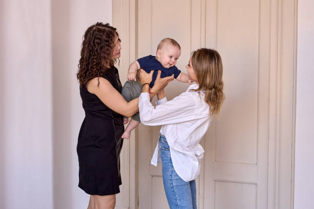 istock Babysitter holds infant while mother is leaving him before work. 1347491231