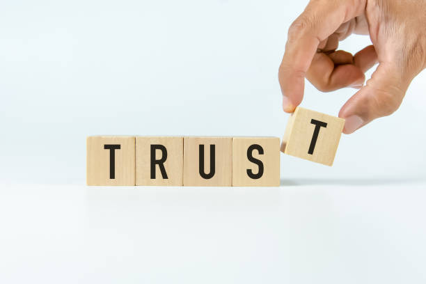 istock 'Trust' text on wooden block with white backgrounds. 1347491303