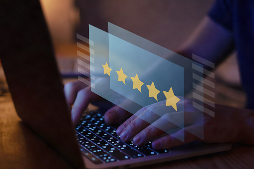 writing review on internet with 5 star rating, reputation management concept