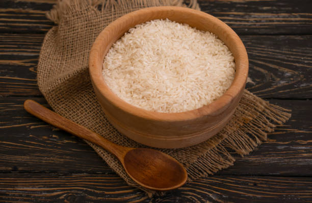 istock raw rice natural wooden plate 1347492852