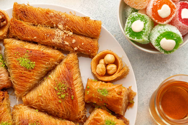 istock Various Turkish sweets and cup of tea on white textured background 1347492877