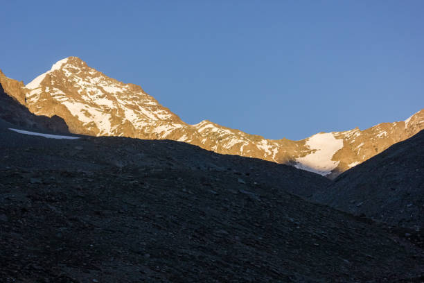 istock Sunlight hitting the snow capped peak of a Himalayan mountain 1347495186