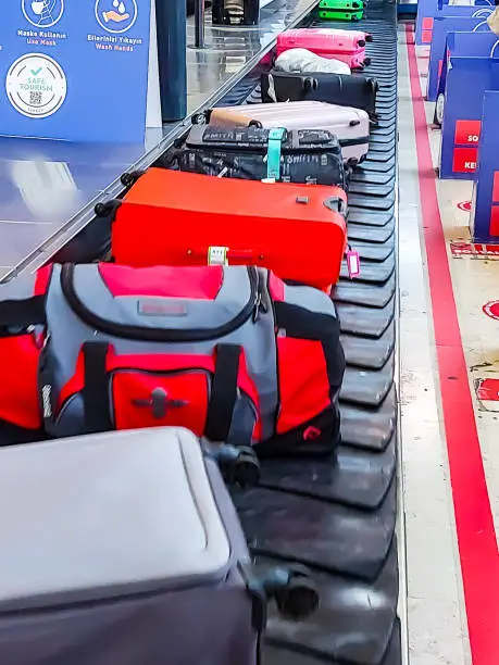 People wait on the treadmill for their luggage