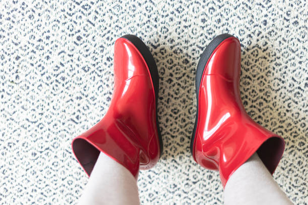 Red boots against the background of black and white pattern.