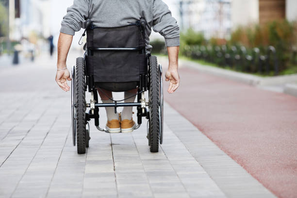 man in wheelchair riding outdoors - paraplegisk bildbanksfoton och bilder