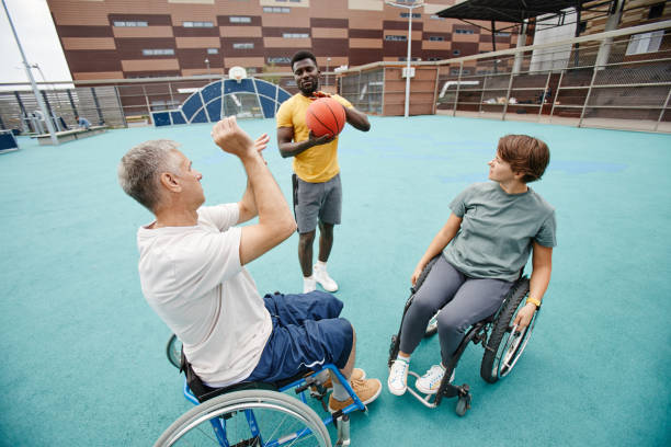 istock Couple with disability learning to play basketball 1347496942