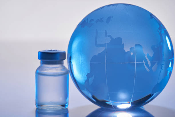 istock vaccine bottle and glass globe 1347498145