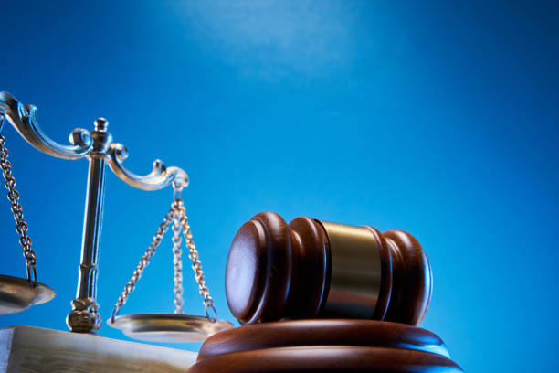 istock gavel hammer and  libra scale against blue background 1347498547