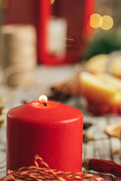 istock Burning Christmas candle close up on wooden table 1347498574