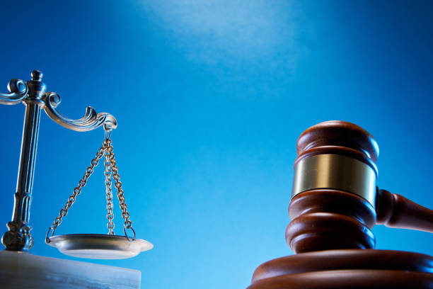 istock gavel hammer and  libra scale against blue background 1347499475