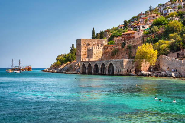 Beautiful Mediterranean Sea beach against the city walls of Alanya stock photo