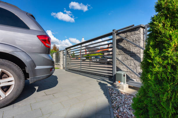 Driveway with an automatic gate Driveway of a modern single-family house with an automatic gate gate stock pictures, royalty-free photos & images