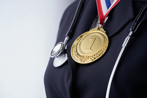 midsection of  wowen with golden medal and stethoscope