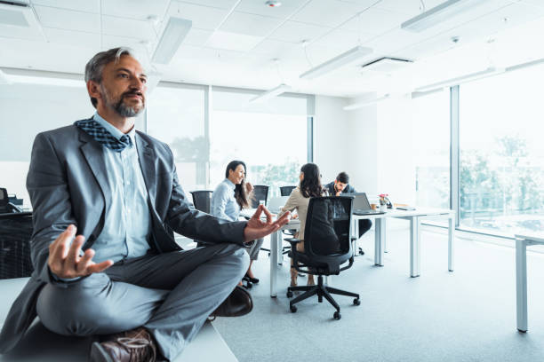 istock Mature Exhausted businessman meditating in office. 1347502306