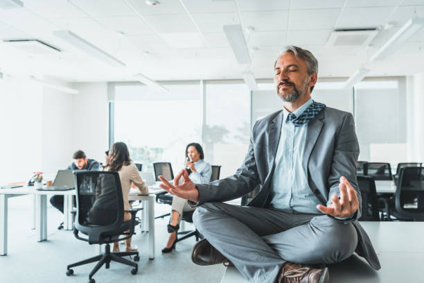 istock Mature Exhausted businessman meditating in office. 1347502310