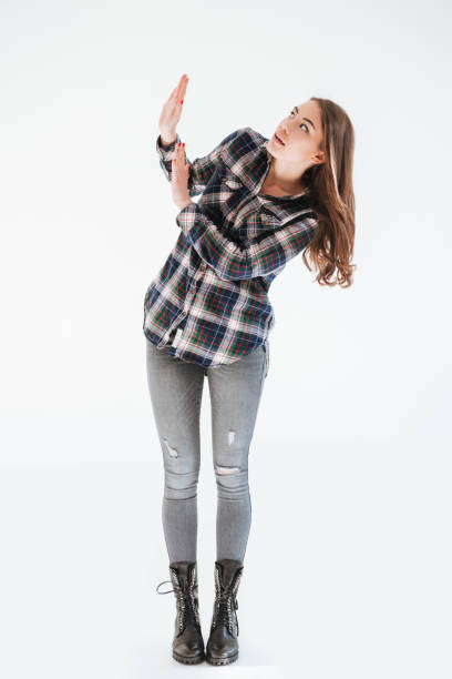 istock Scared shocked young woman standing and protecting by hands 1347504061