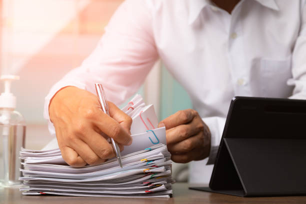 istock Businessman signing document after reading the agreement in office, hand writing. 1347504692