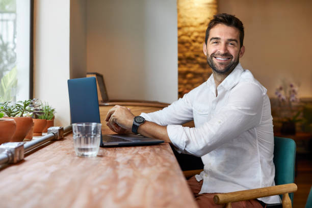 istock Portrait of man using laptop while sitting in cafe 1347505668