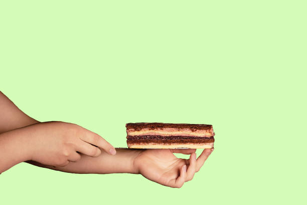 istock a cake on a background with a woman's hand is a modern dish of a minimalistic concept that copies the space. The concept of a cafe or bakery with desserts. your choice, a good offer. profitable. 1347506552